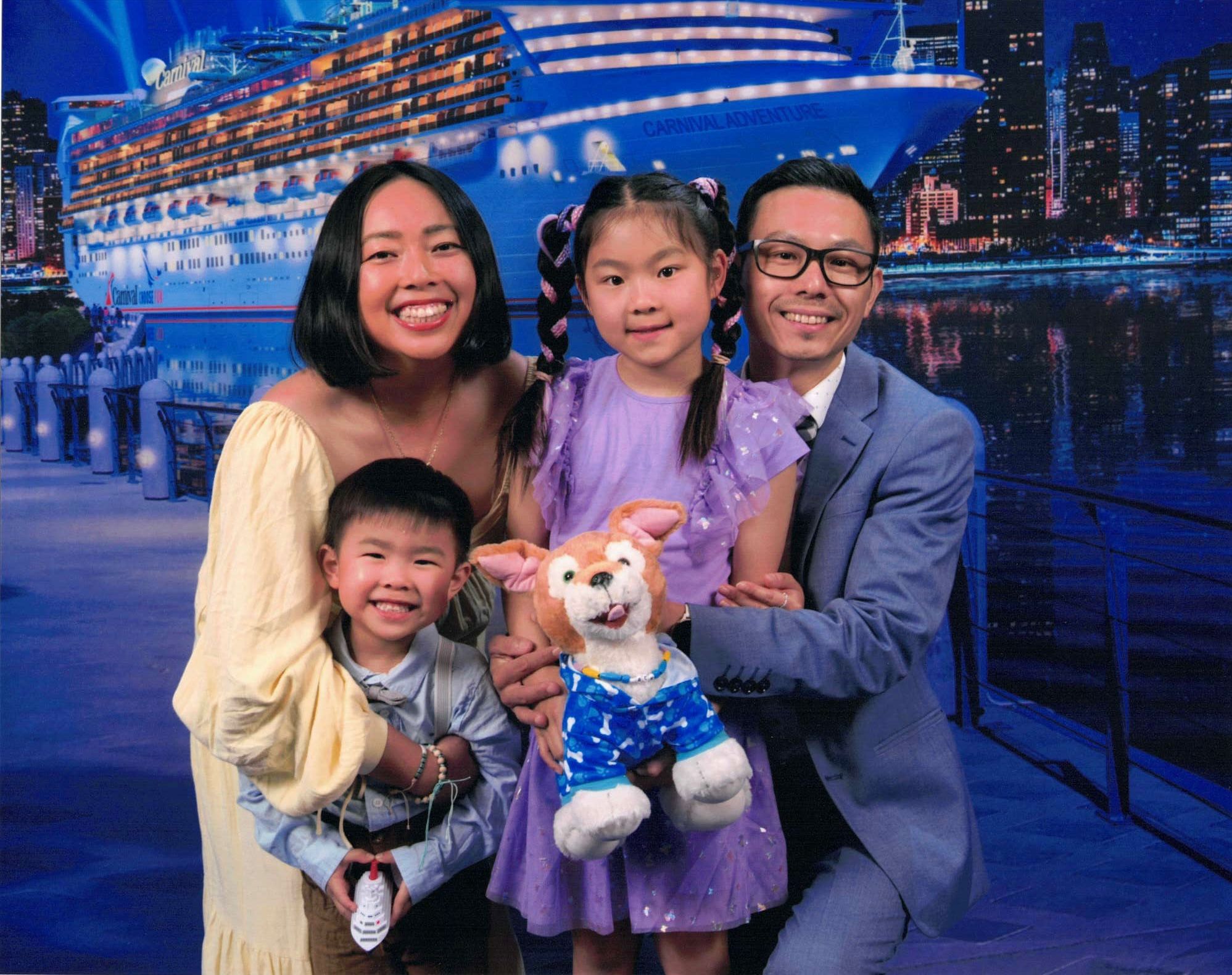 Jen, Zen, Clara and Atticus together in front of a cruise ship