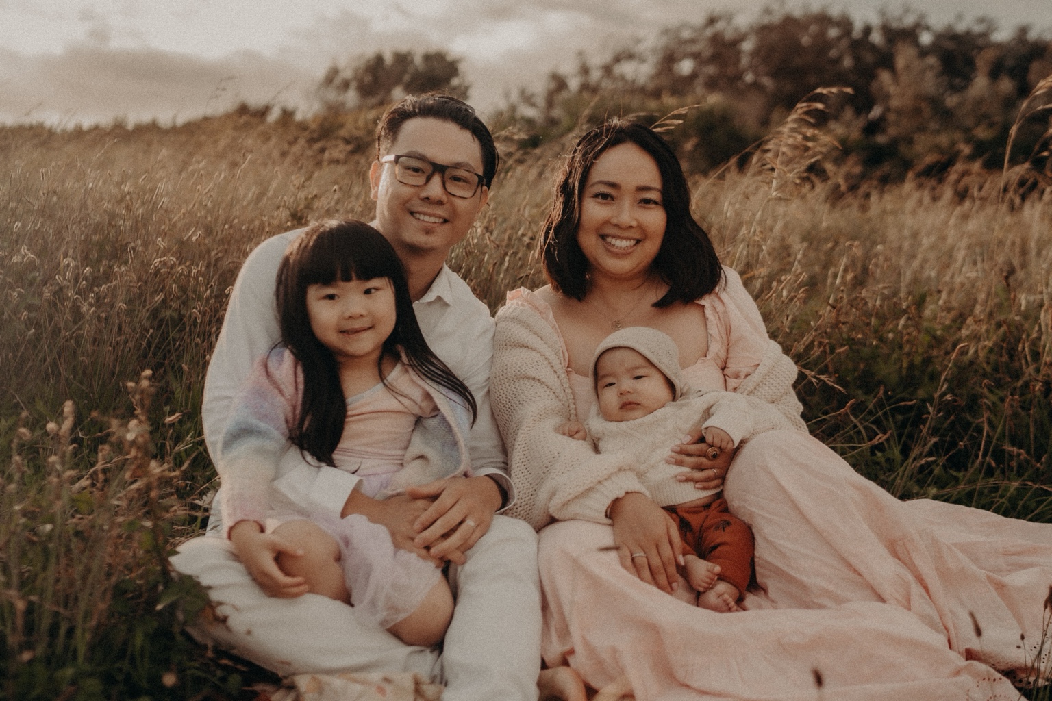Zen, Jen, Clara and baby Atticus together in a field